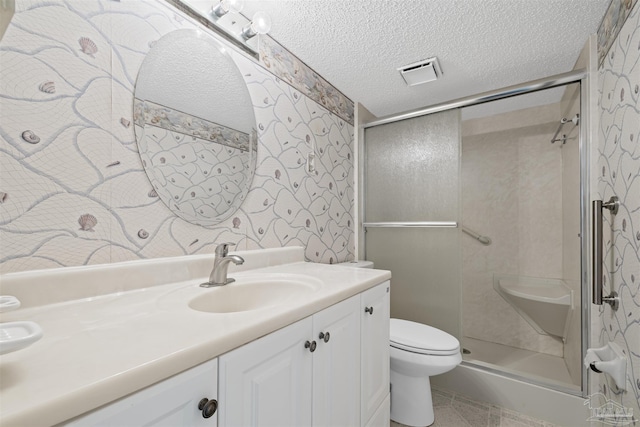 4831 E Olive Rd Unit 2A, Pensacola, FL 32514 - bathroom featuring toilet, vanity, wallpapered walls, a shower stall, and a textured ceiling