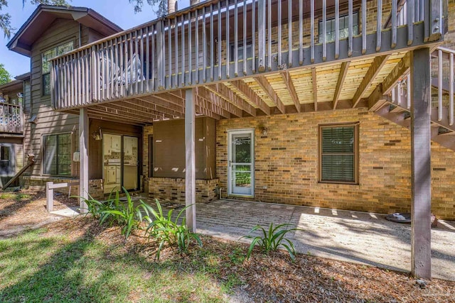4831 E Olive Rd Unit 2A, Pensacola, FL 32514 - back of property with brick siding, a wooden deck, and a patio area