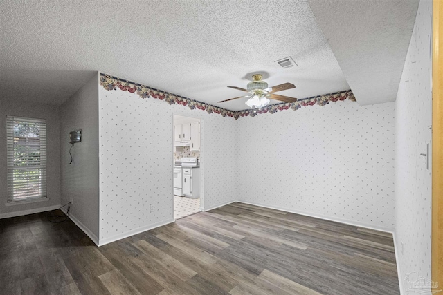 4831 E Olive Rd Unit 2A, Pensacola, FL 32514 - unfurnished room with wallpapered walls, wood finished floors, ceiling fan, a textured ceiling, and baseboards