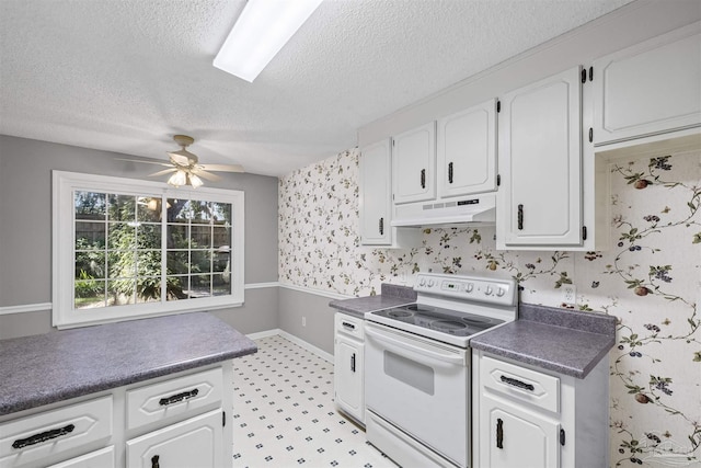 4831 E Olive Rd Unit 2A, Pensacola, FL 32514 - kitchen with white range with electric cooktop, under cabinet range hood, a textured ceiling, wallpapered walls, and white cabinetry