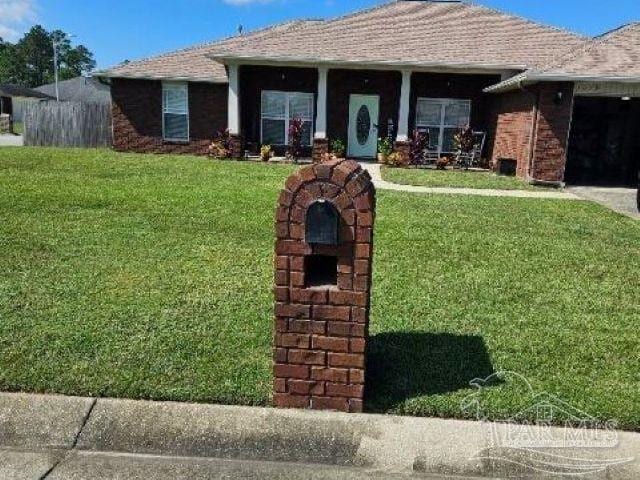 single story home featuring a garage and a front lawn