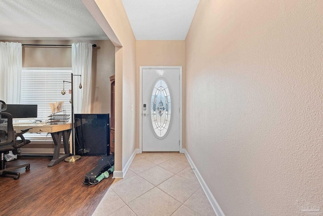 entryway featuring a textured ceiling and light tile patterned floors