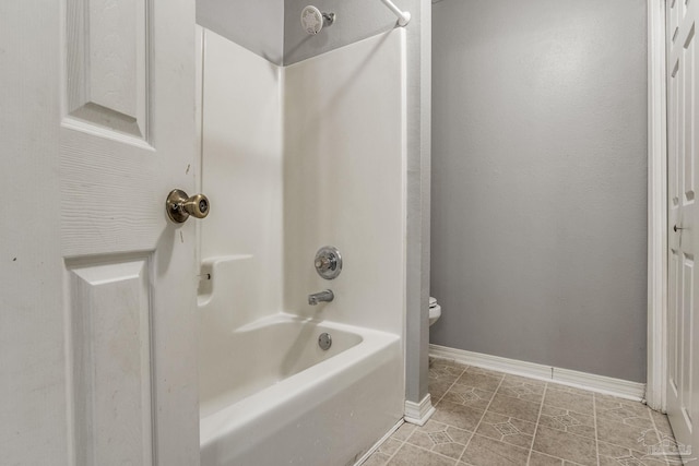 bathroom with tile patterned floors, toilet, and shower / tub combination