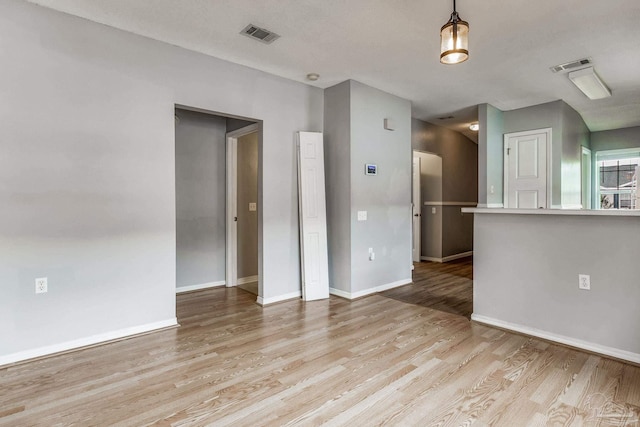 empty room with light hardwood / wood-style floors