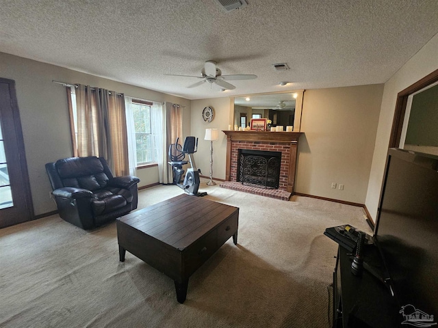 living area featuring baseboards, visible vents, a fireplace, ceiling fan, and light colored carpet