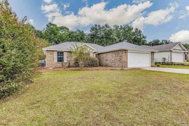 ranch-style house featuring a front yard and a garage