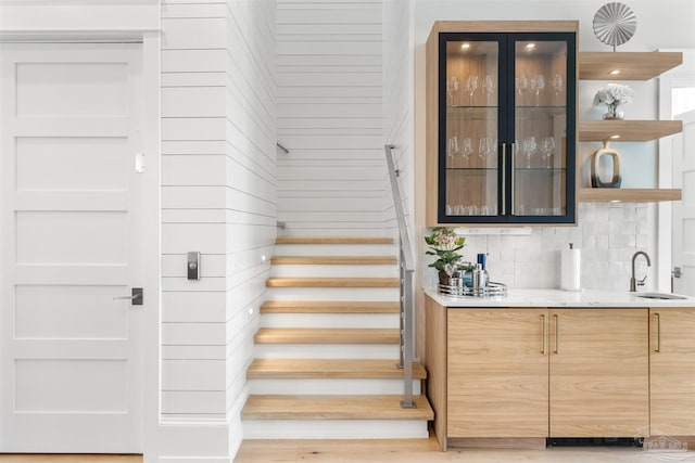 stairway with hardwood / wood-style flooring and sink