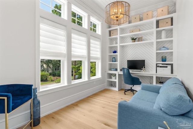 office area featuring hardwood / wood-style flooring, built in features, and a chandelier