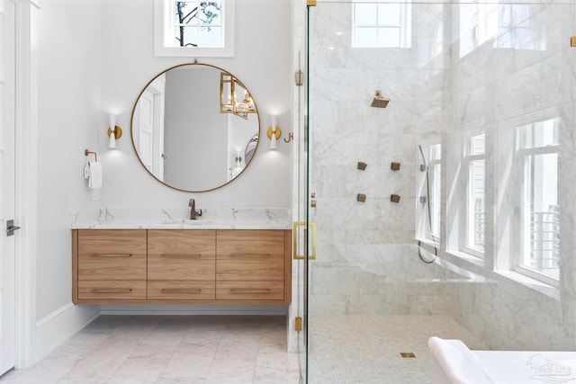 full bath featuring marble finish floor, a shower stall, a wealth of natural light, and vanity