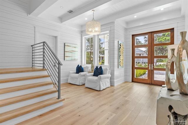 foyer featuring french doors, visible vents, light wood-style flooring, stairway, and beamed ceiling