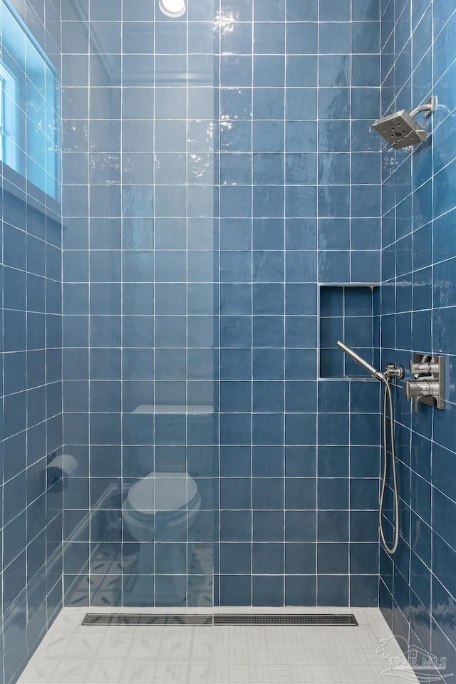 bathroom with a tile shower