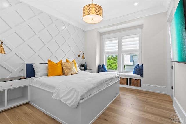 bedroom featuring recessed lighting, an accent wall, baseboards, light wood-style floors, and crown molding