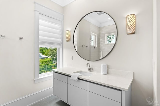 bathroom featuring a wealth of natural light, vanity, and baseboards