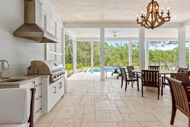 view of patio featuring outdoor dining area, a sink, exterior kitchen, grilling area, and a fenced in pool