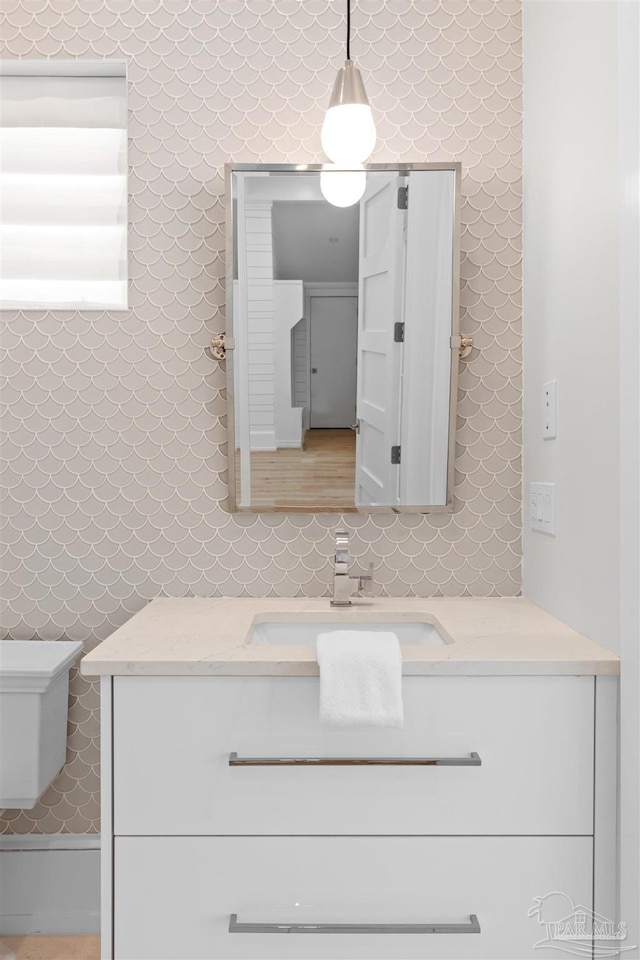 bathroom featuring vanity and toilet