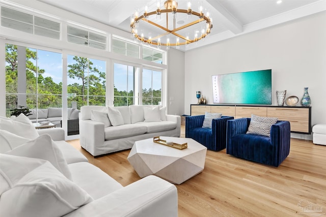 living room with hardwood / wood-style flooring, an inviting chandelier, and beamed ceiling