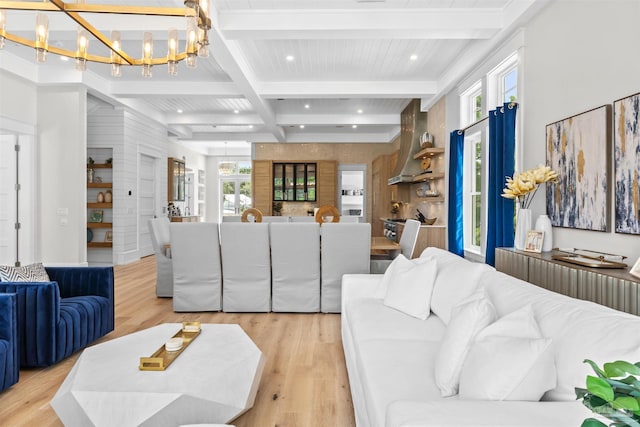 living area featuring recessed lighting, coffered ceiling, light wood-style floors, beamed ceiling, and an inviting chandelier