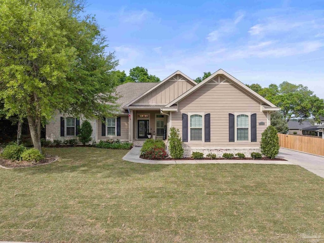 8926 Salt Grass Dr, Pensacola, FL 32526 - view of front of home featuring board and batten siding, a front lawn, and fence
