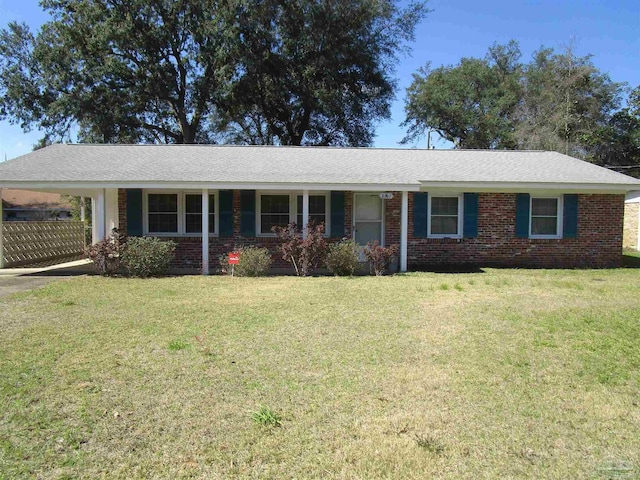 ranch-style house with brick siding, a front lawn, and an attached carport