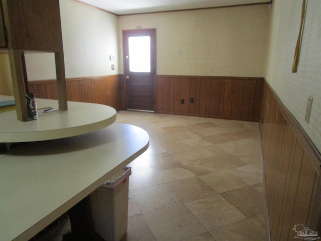 interior space with wood walls and wainscoting