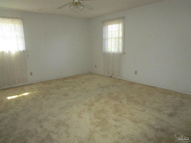 spare room with carpet floors and ceiling fan