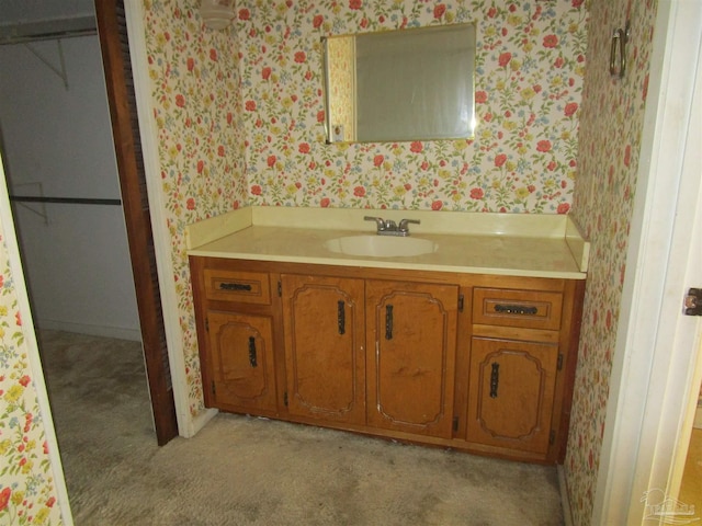 bathroom with vanity and wallpapered walls