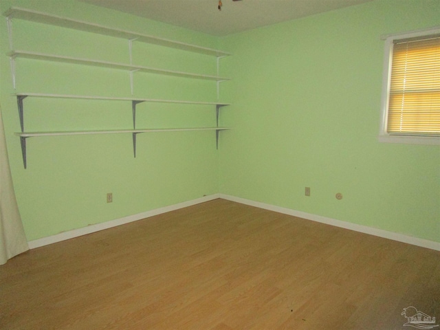 empty room featuring baseboards and wood finished floors