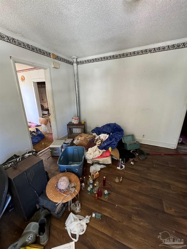 interior space featuring crown molding, hardwood / wood-style floors, and a textured ceiling