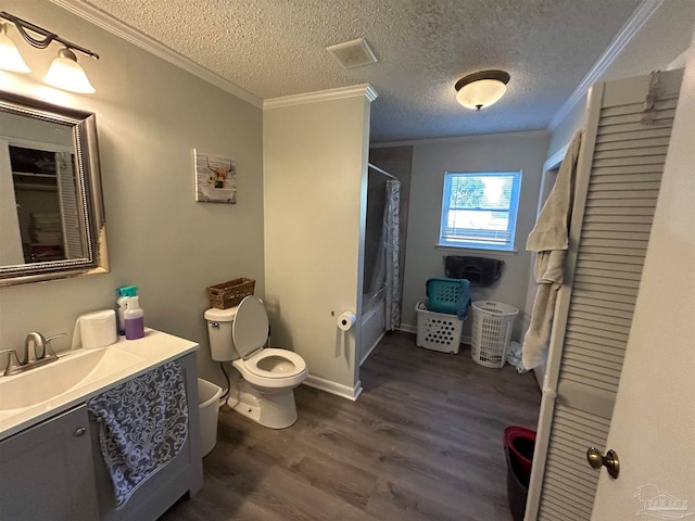 bathroom featuring vanity, a textured ceiling, hardwood / wood-style flooring, crown molding, and toilet