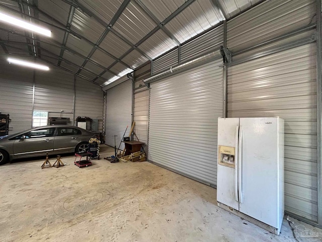 garage with white fridge with ice dispenser