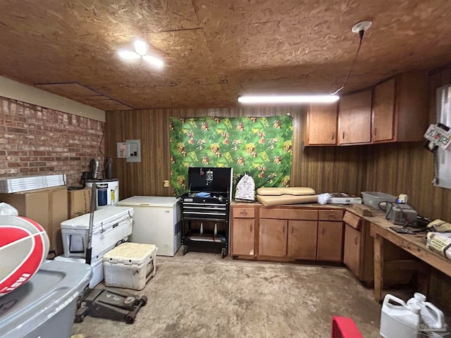 kitchen featuring brick wall