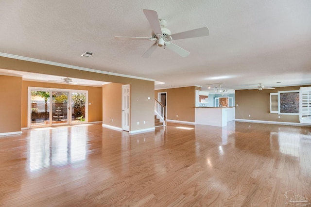 unfurnished living room with baseboards and a ceiling fan