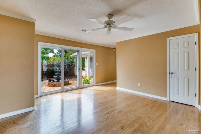 spare room featuring crown molding, baseboards, ceiling fan, a textured ceiling, and light wood-style flooring