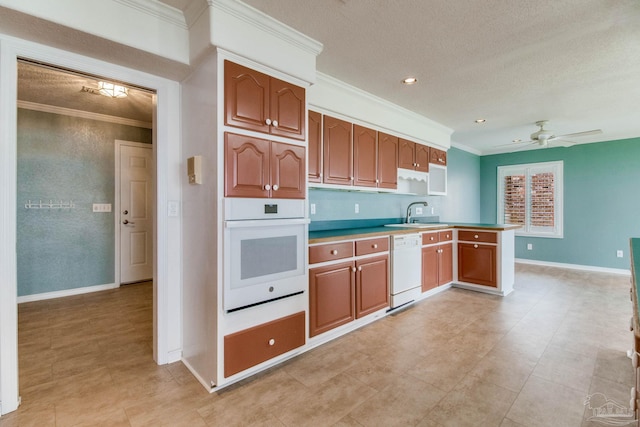 kitchen with white appliances, a textured ceiling, and crown molding