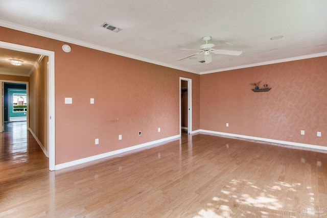 empty room with baseboards, ornamental molding, light wood-style flooring, and ceiling fan