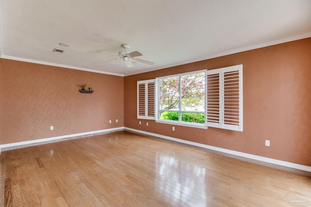 empty room featuring visible vents, baseboards, ceiling fan, and light wood-style floors