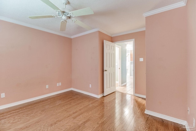 empty room with light wood-style floors, baseboards, ornamental molding, and a ceiling fan