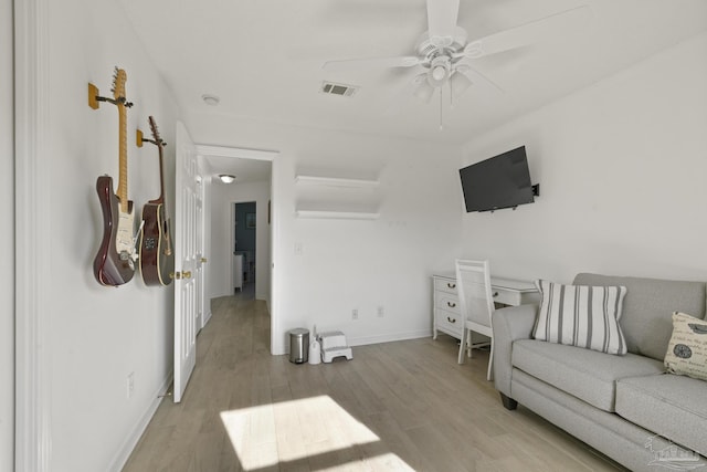 living room featuring ceiling fan and light hardwood / wood-style flooring