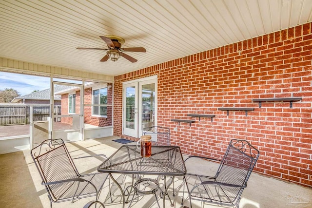 unfurnished sunroom featuring a healthy amount of sunlight and ceiling fan