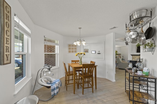 dining room with an inviting chandelier and a textured ceiling