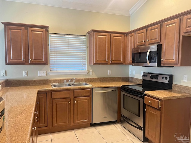 kitchen featuring stainless steel appliances, sink, light tile patterned floors, and crown molding