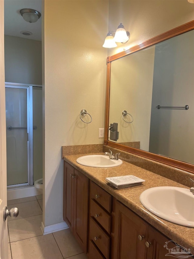 bathroom featuring vanity, an enclosed shower, and tile patterned floors