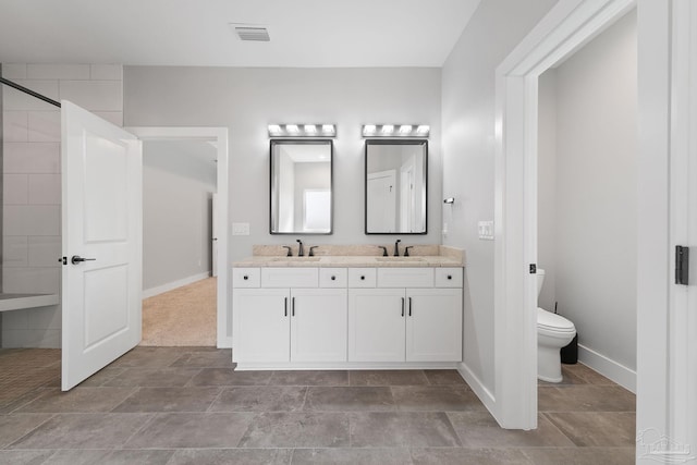 bathroom featuring vanity and toilet