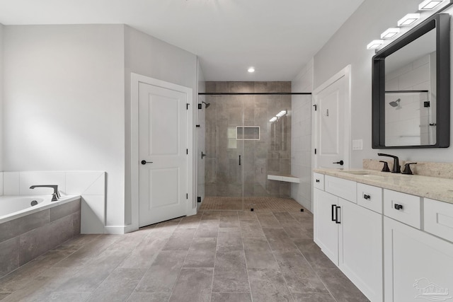 bathroom with vanity and independent shower and bath