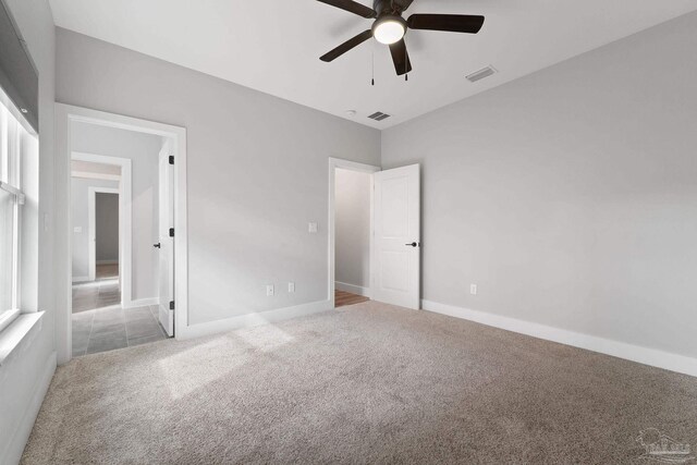 unfurnished bedroom featuring ceiling fan and carpet floors