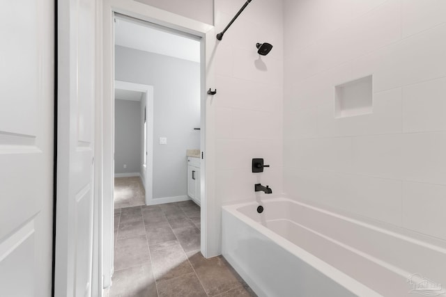 bathroom featuring vanity, tiled shower / bath combo, and tile patterned floors