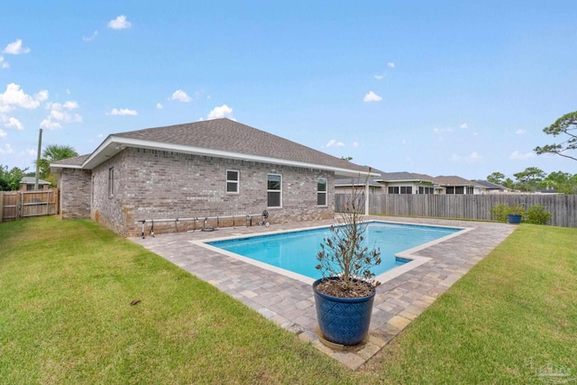 view of pool with a lawn