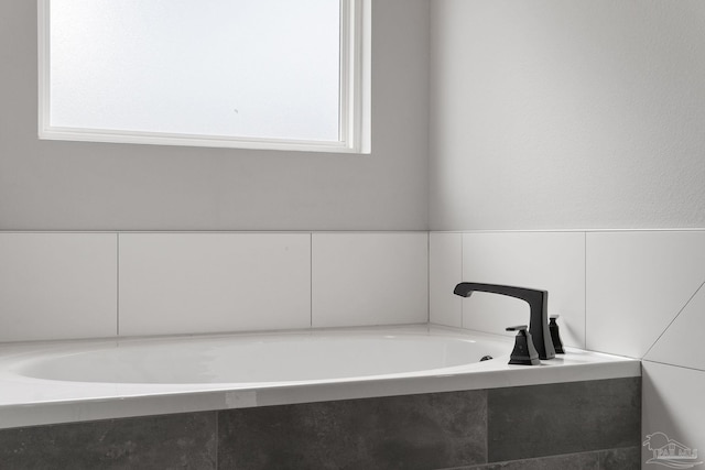 bathroom with a tub to relax in