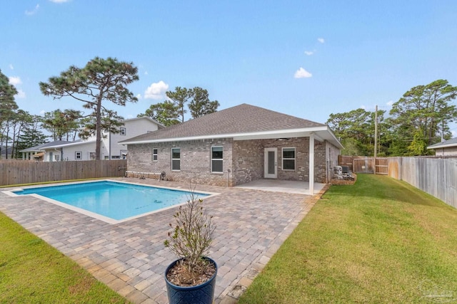 view of pool with a yard and a patio