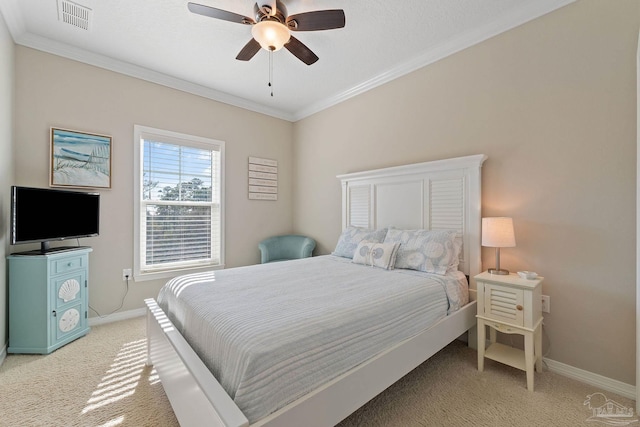 carpeted bedroom featuring ceiling fan and ornamental molding